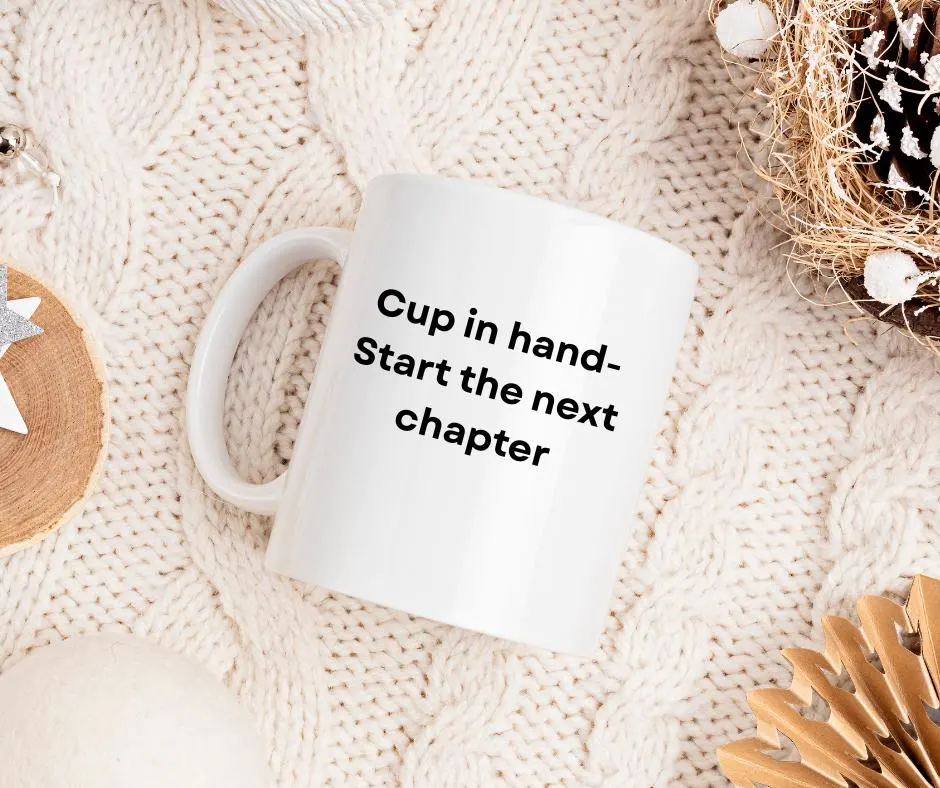 White mug with text 'Cup in hand- Start the next chapter' on a textured surface.