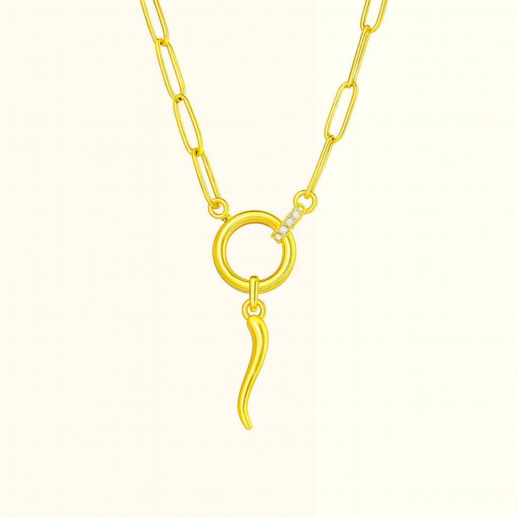 Gold necklace with Italian horn pendant on a blush background