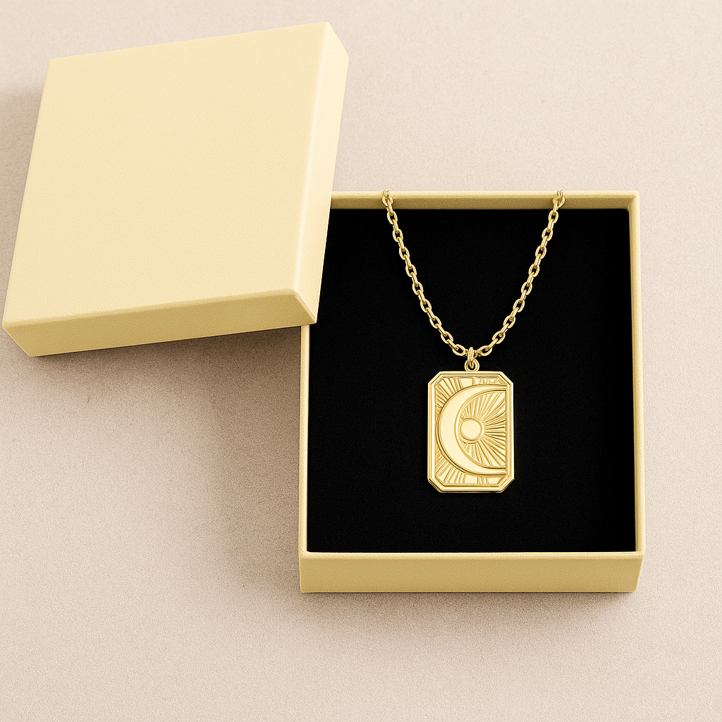 Gold necklace with a Sunburst Moon pendant in an open jewelry box on a beige background