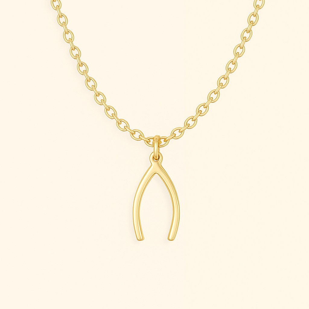 Gold wishbone pendant necklace on a beige background