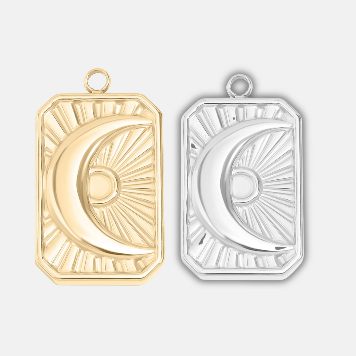 Gold and silver moon-shaped pendants on a light gray background