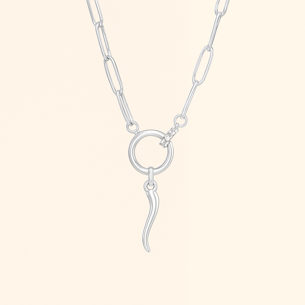 Silver paperclip necklace with an Italian Horn pendant on a blush background