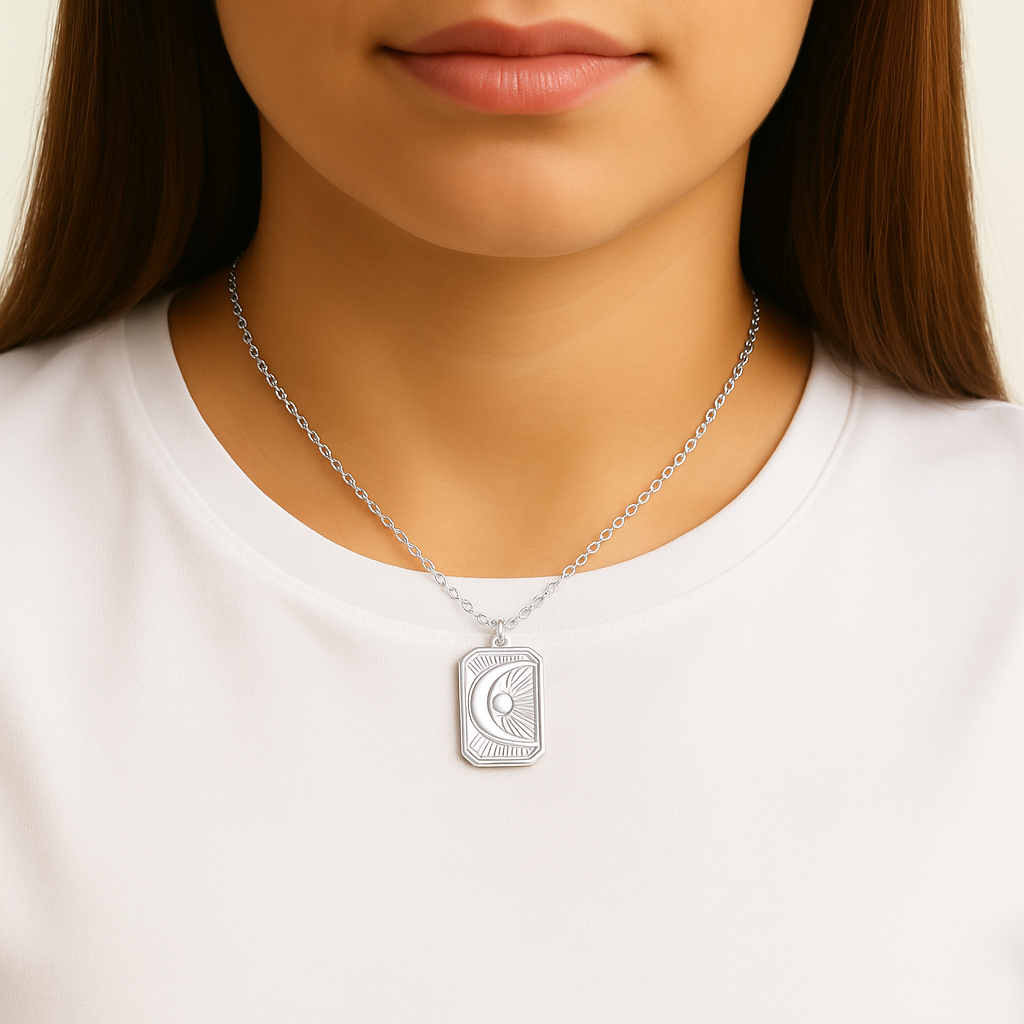 Silver necklace with a Sunburst Moon pendant worn by a person on a white background