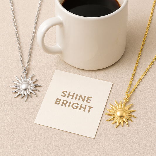 Sun-shaped necklaces on a beige surface with a white mug of coffee and a 'SHINE BRIGHT' card.