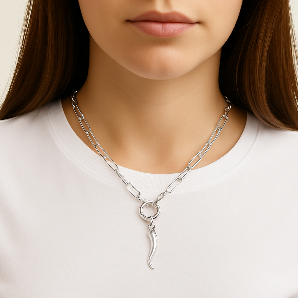 Silver paperclip chain necklace with an Italian Horn pendant worn by a person on a white background