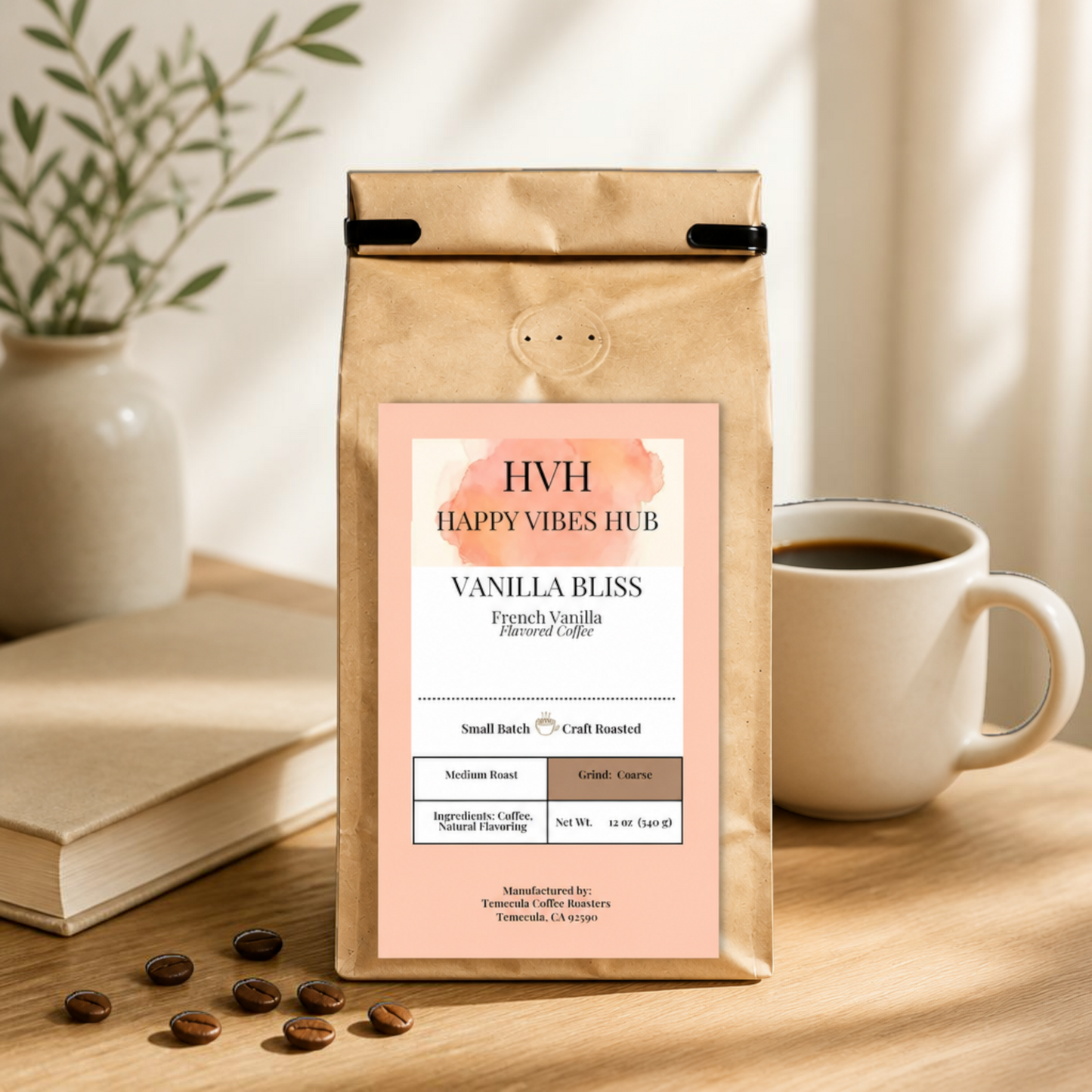 Happy Vibes Hub compostable kraft bag of Vanilla Bliss coffee beans on a wooden table with a cup of coffee and book